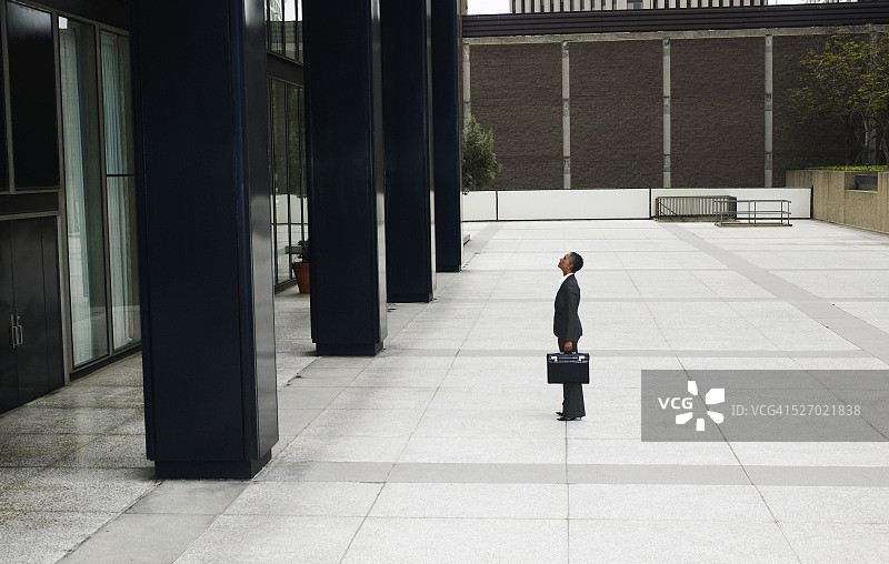 抬头看办公楼的女商人图片素材