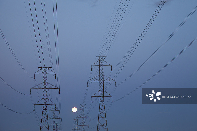黄昏时分的输电线路；加拿大博蒙特阿尔伯塔图片素材