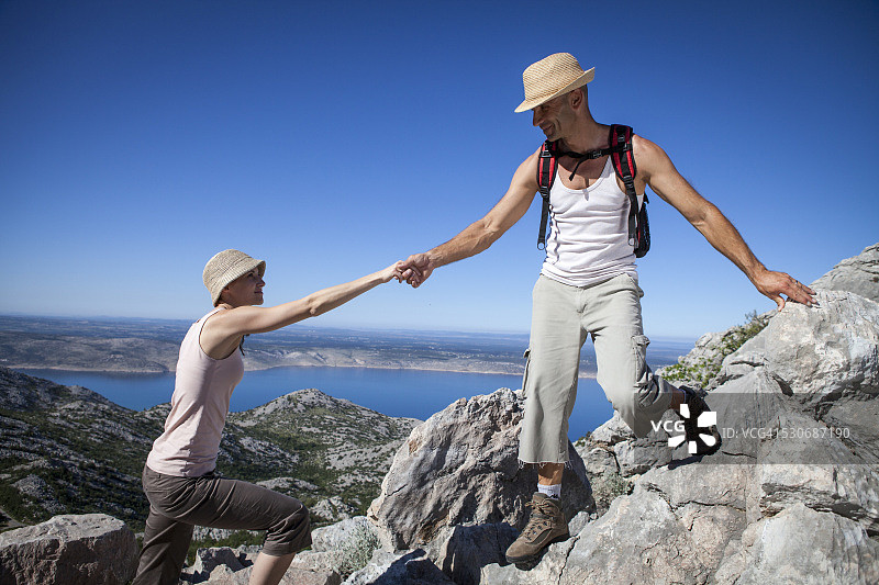 克罗地亚帕克莱尼察，情侣在蓝天下攀登图片素材