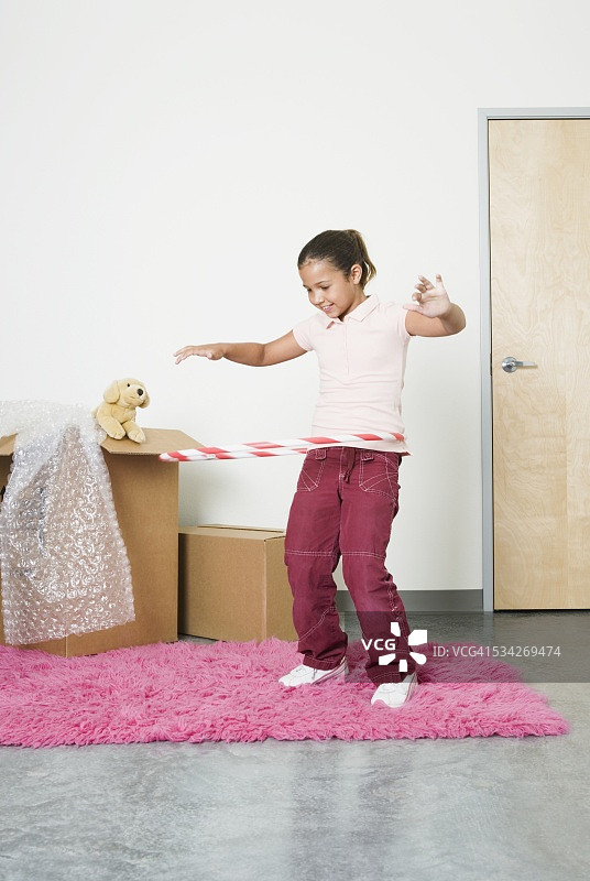 在新的卧室里玩呼啦圈的女孩图片素材