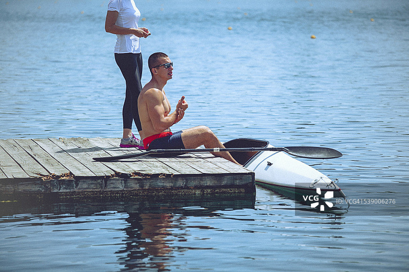 年轻运动员和教练准备皮划艇冲刺训练图片素材