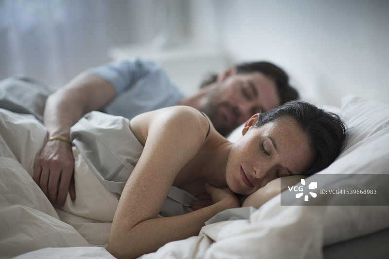 美国新泽西州，一对夫妇晚上在床上睡觉图片素材