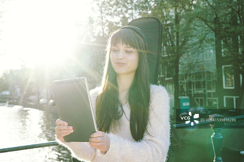 使用平板电脑的快乐年轻女人肖像图片素材