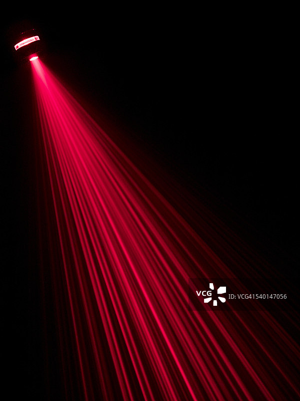 红色激光束照射在黑色表面上图片素材