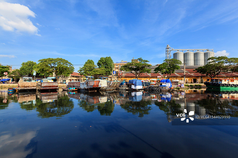 胡志明市第八郡运河上倒映的彩色船只图片素材