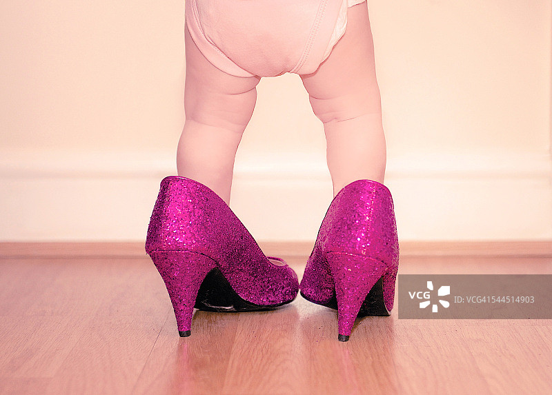 幼儿穿着妈妈的鞋子图片素材