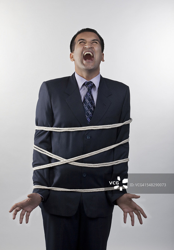 被绳子捆绑的商人图片素材