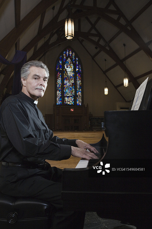 在钢琴前的牧师图片素材