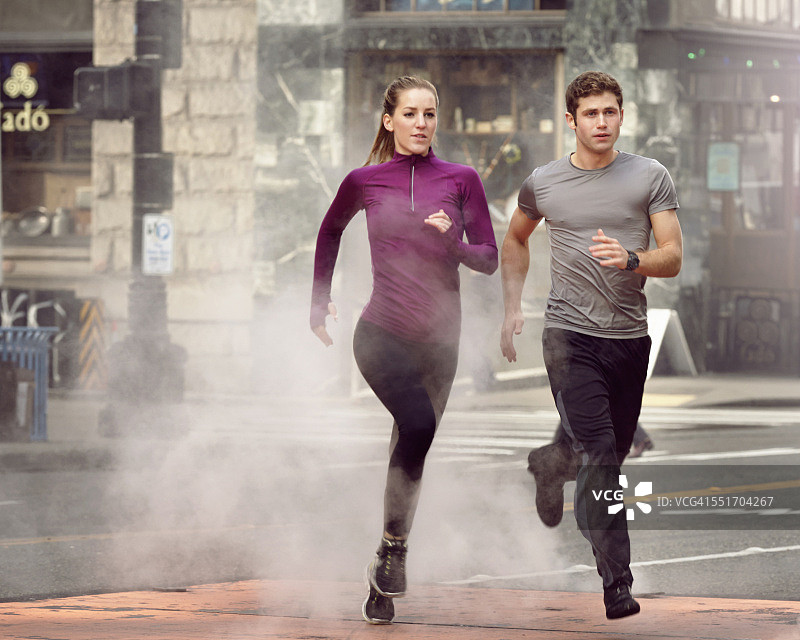年轻男女在美国西雅图先锋广场蒸汽中奔跑图片素材