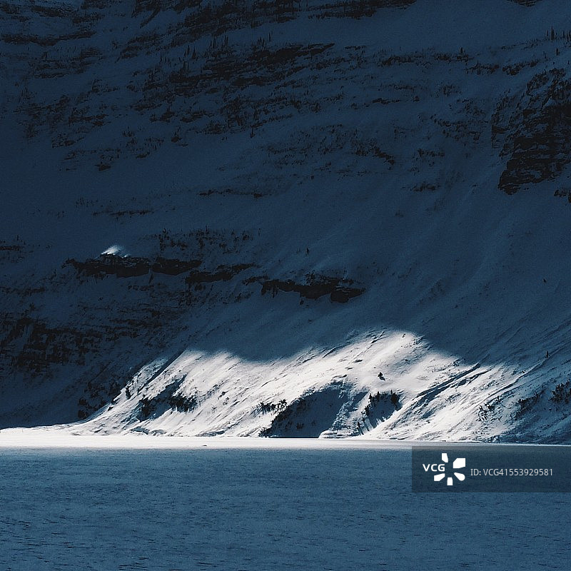 阳光洒在白雪皑皑的山壁上图片素材