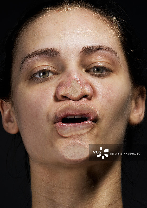 女人的下巴、嘴唇和鼻子紧贴着玻璃图片素材
