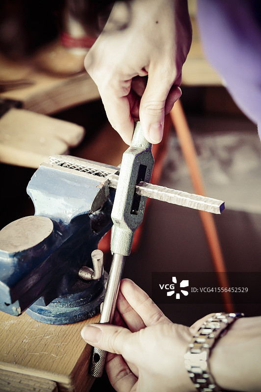 金匠以木纹金工艺制作结婚戒指，准备台钳图片素材