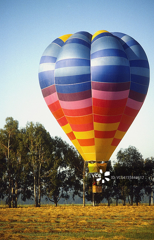 热气球在田野中降落图片素材