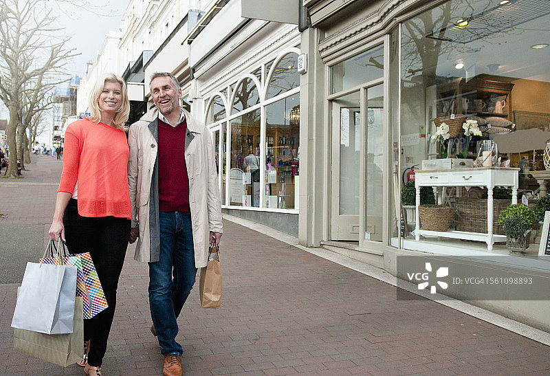 情侣在乡村街道提着购物袋图片素材