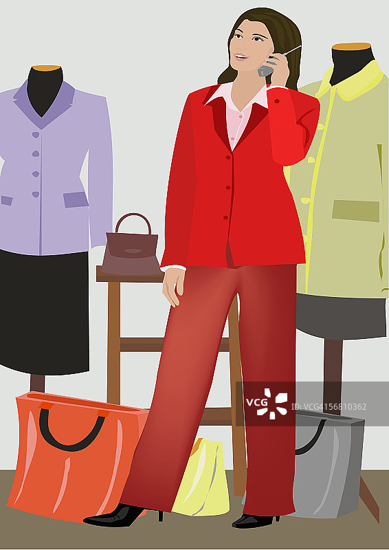 在服装店用手机的女人图片素材