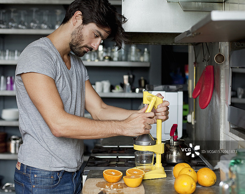 男子榨橙汁图片素材