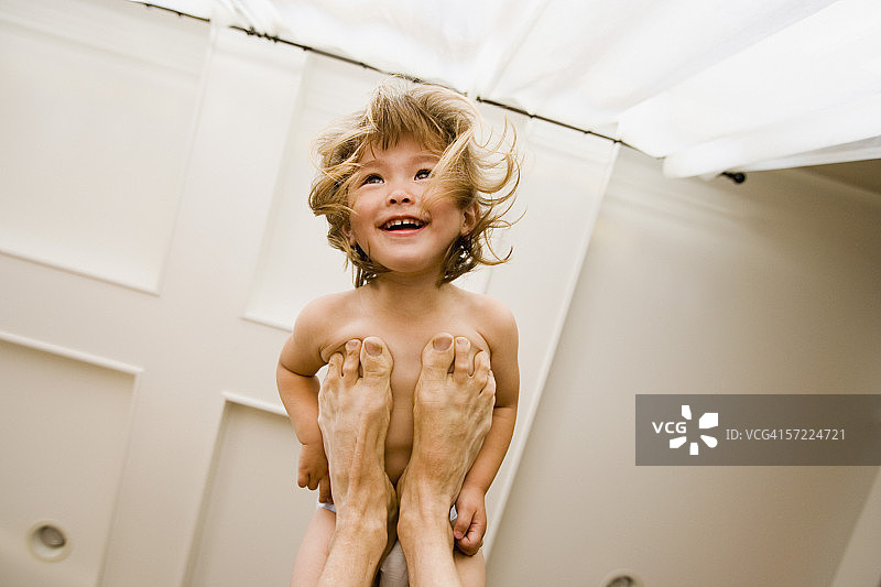 女孩站在父亲脚上的肖像图片素材