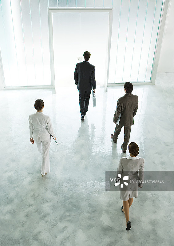 四位高管穿过大厅走向出口图片素材
