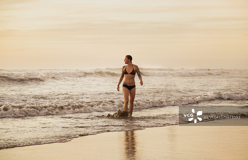 有纹身的女人走出海浪图片素材