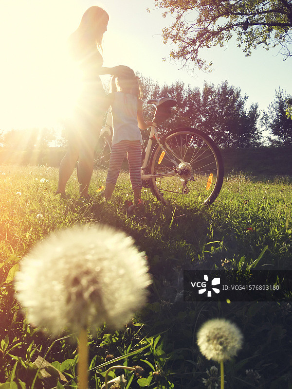日落时分，母女在户外骑自行车图片素材