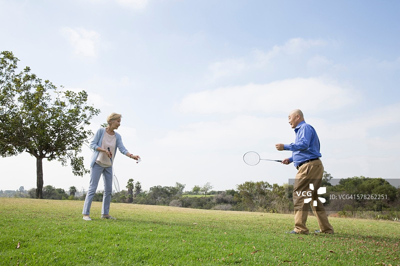 老年夫妇在公园里打羽毛球图片素材