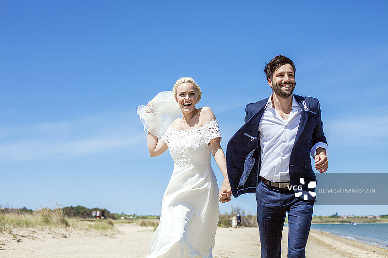 新娘和新郎在海滩上玩耍图片素材