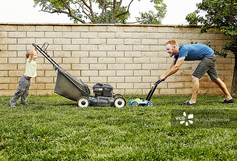 父子在后院修剪草坪图片素材