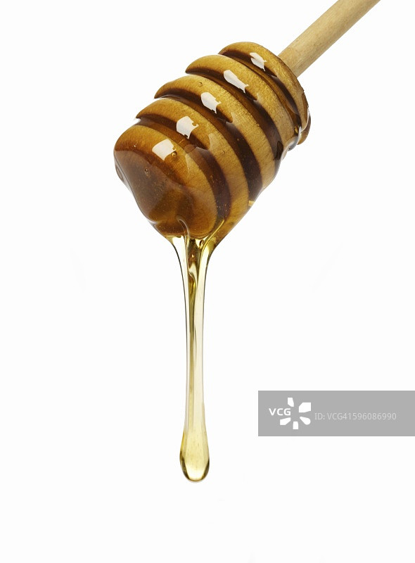 蜂蜜从蜂蜜勺上滴落图片素材