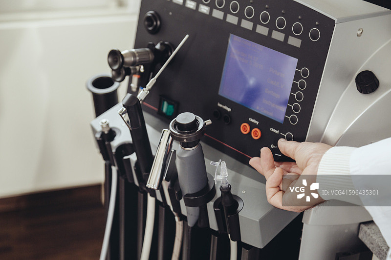 耳鼻喉科医生在诊所调节医疗设备旋钮图片素材