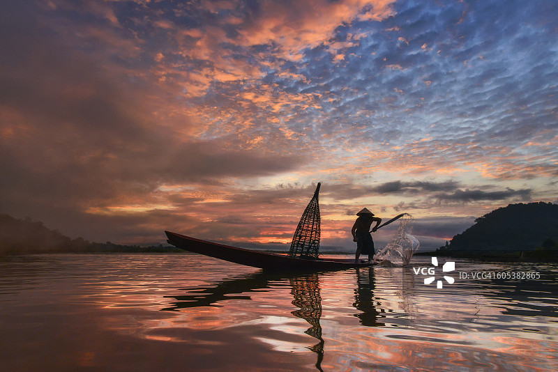 男子在泰国湄公河撒网的轮廓图片素材