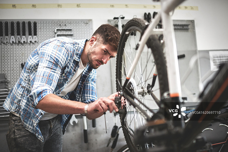 修理自行车变速器的技工图片素材
