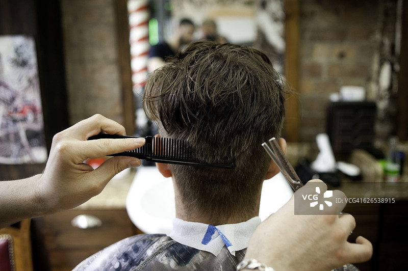 年轻男子在理发店理发图片素材