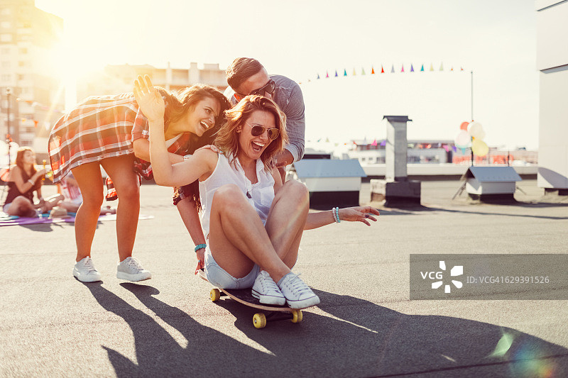 在屋顶露台上玩滑板的青少年图片素材