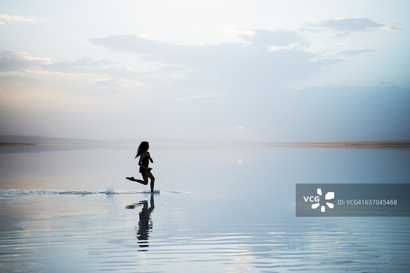 傍晚在湖面上奔跑的舞者图片素材