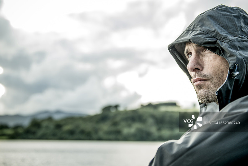 穿着登山服站在威尔士巴拉湖岸边的男人图片素材