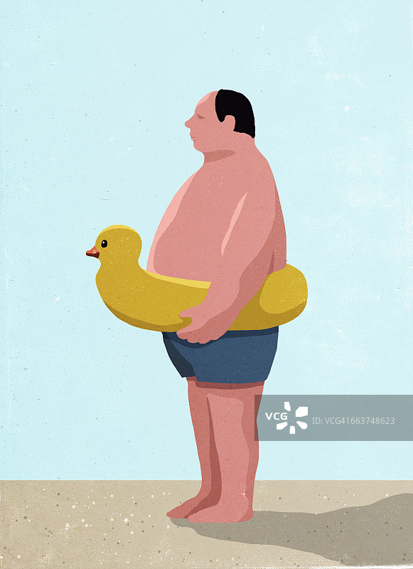 男人在海滩上戴着充气橡皮鸭圈的侧面像图片素材