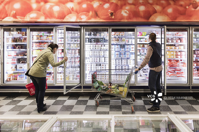 夫妇在超市冷藏区选择商品图片素材