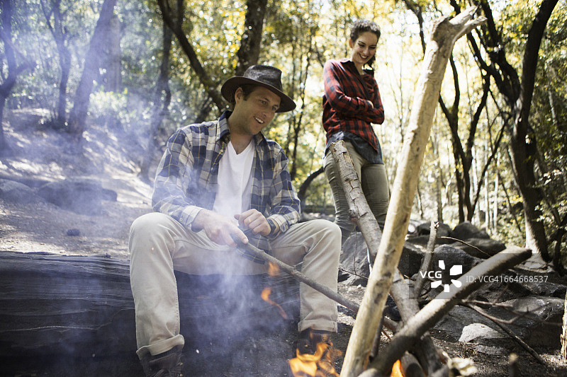 美国加州阿卡迪亚森林中生火的年轻男女徒步者图片素材