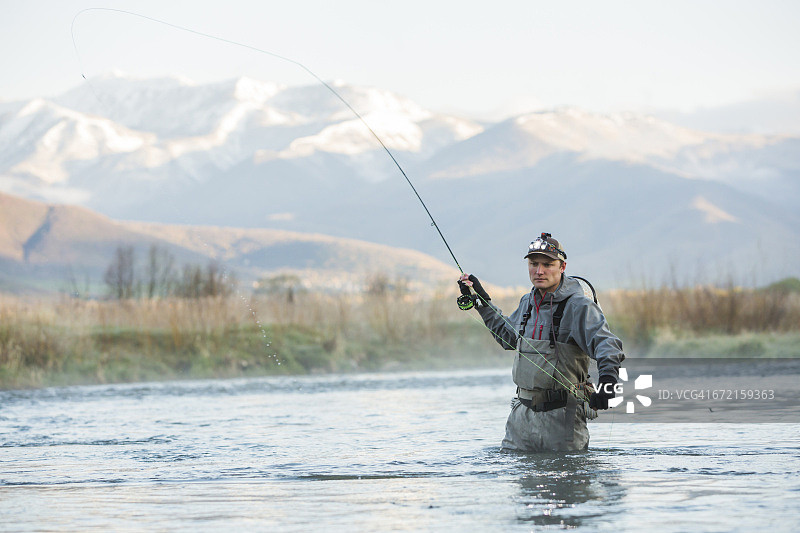白人男子在河里飞蝇钓图片素材