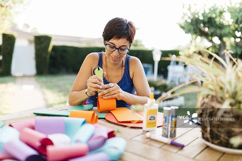 女人在花园的桌子上做手工图片素材