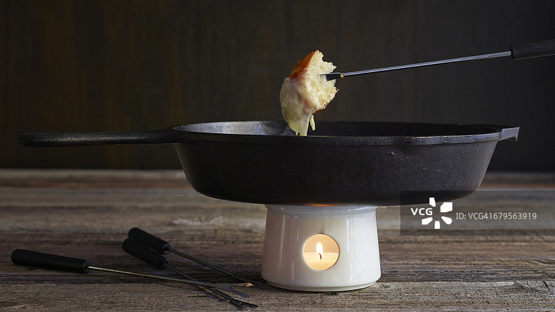 木质砧板上的奶酪火锅与面包图片素材