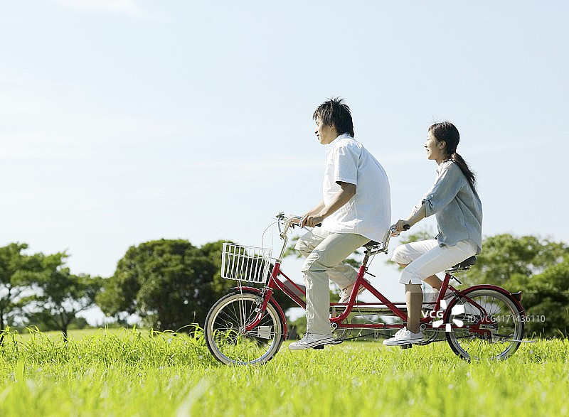 年轻情侣骑双人自行车图片素材