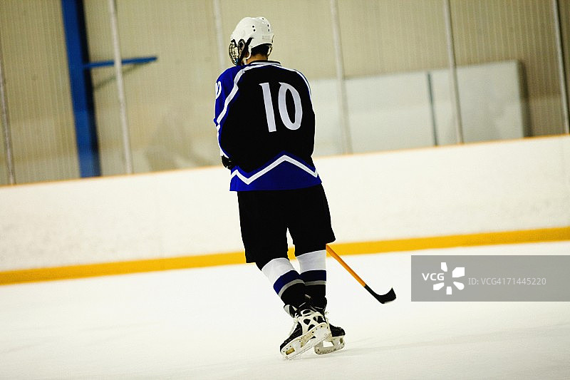冰球运动员打冰球的背影图片素材