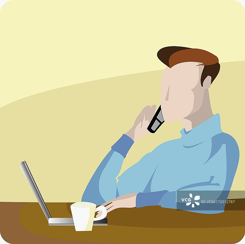 年轻男人使用笔记本电脑并用手机通话图片素材