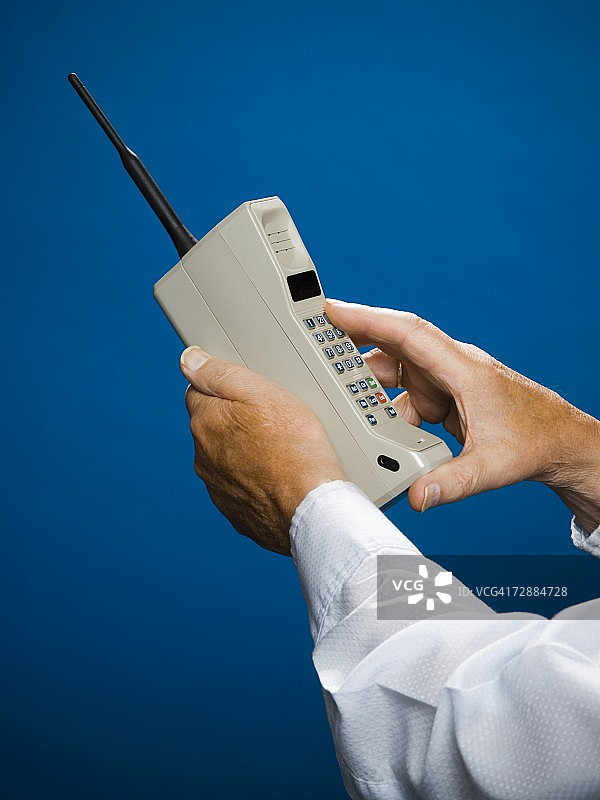 用老式无线电话打电话的老年男人图片素材