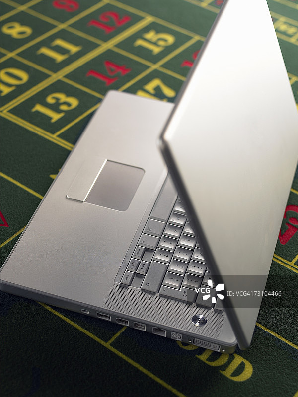 轮盘赌桌上的笔记本电脑图片素材