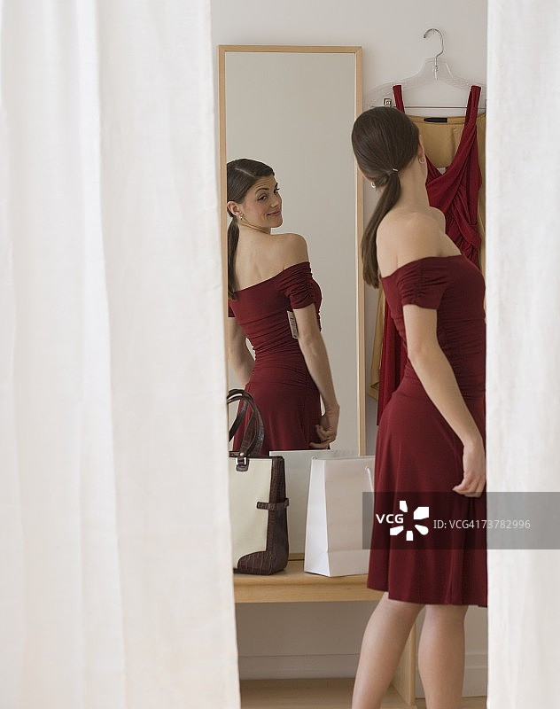 身穿晚礼服的女人正在照镜子图片素材