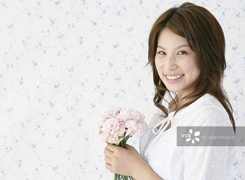 手捧鲜花的日本女人，面带微笑图片素材