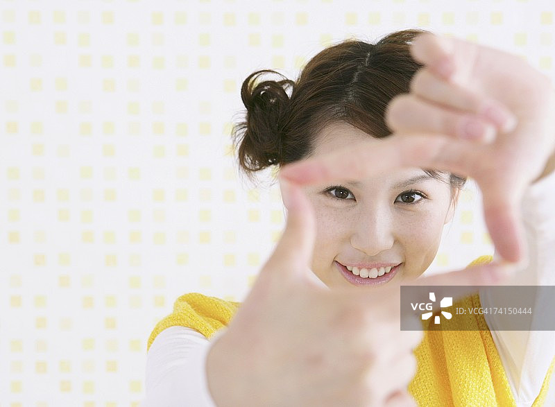 透过手指看镜头的日本女人图片素材