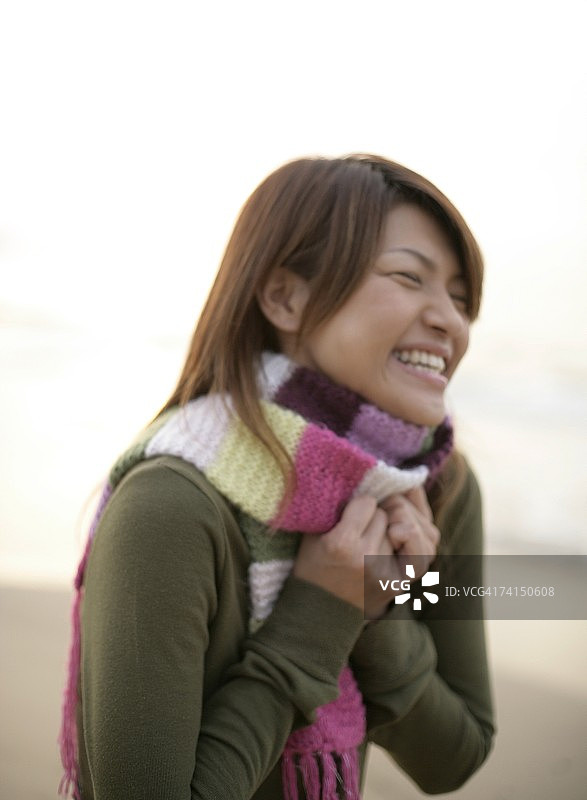 在海滩上微笑行走的日本女人图片素材
